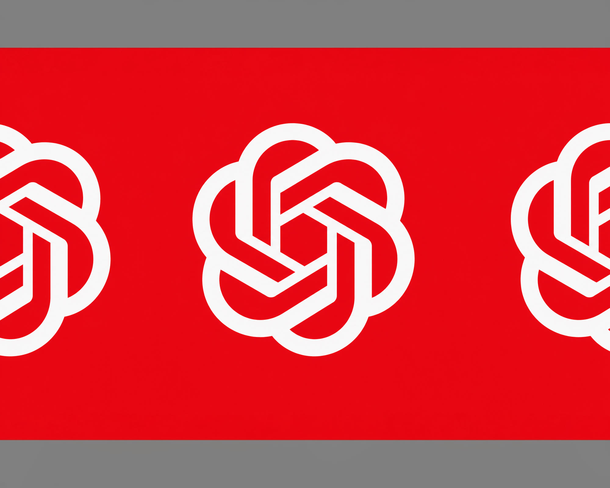 A red banner with white interlocking geometric shapes is centered on a gray background.